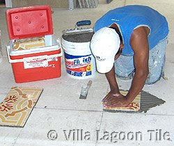 Using hand pressure to set Cuban tile