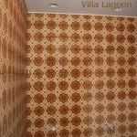Two walls of the men's room of the Flying Iguana, during construction. Villa Lagoon Tile's "Bocassio Gold" decorative cement tile are installed, with the photo taken before grouting and the final sealing.