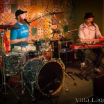 A good view of the patchwork cement tile used as a backdrop of the bandstand at the Flying Iguana, during a live music performance.