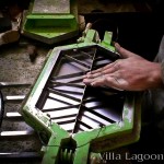 Cement tile production. The Moroccan artisan is inserting the cement tile pattern mold into the shape mold.