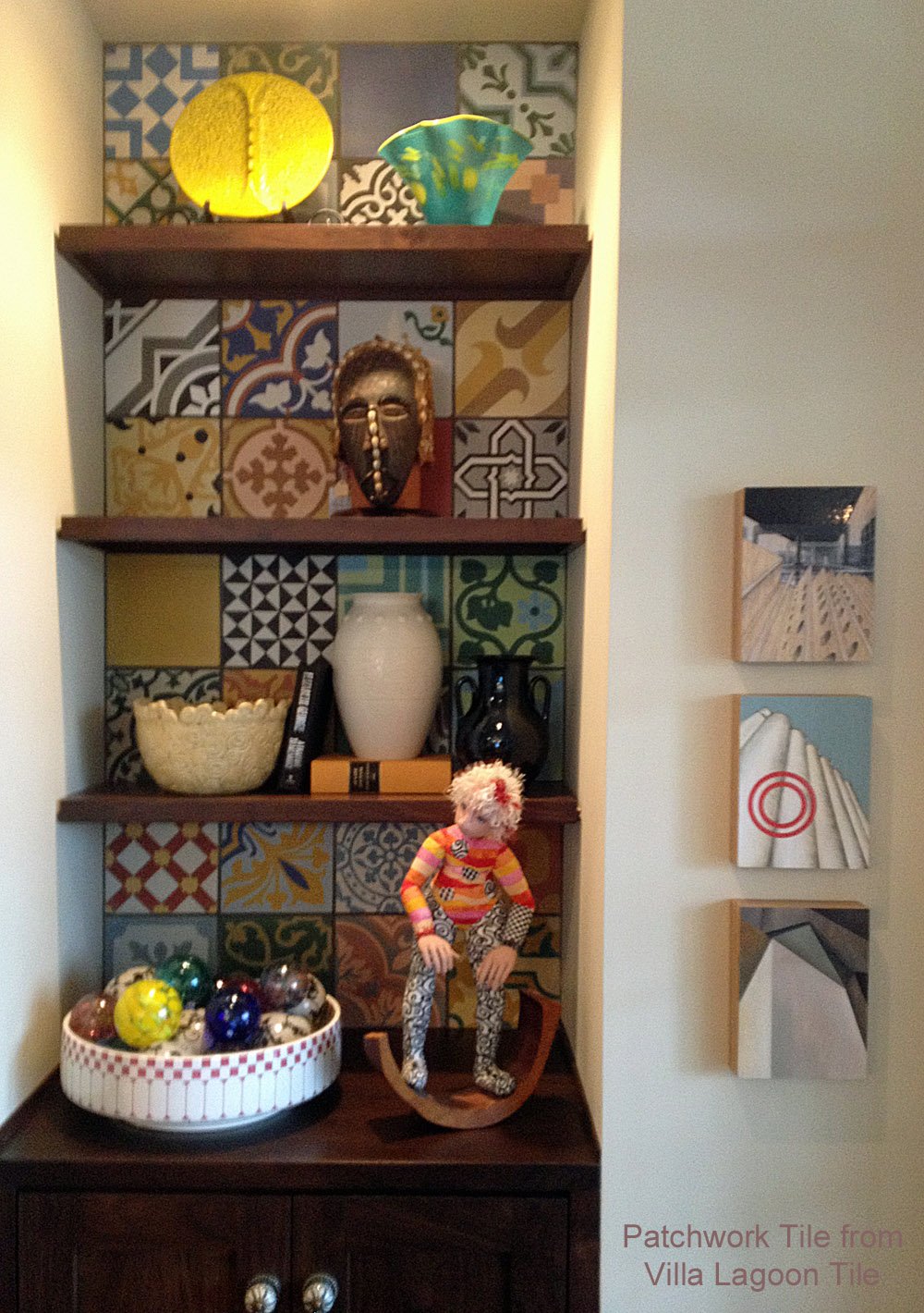 Built in shelves with colorful patchwork tile as a back feature