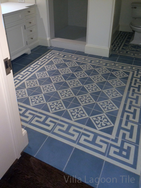 Beautiful blue and gray cement tile from Villa Lagoon Tile accents this white bathroom. 