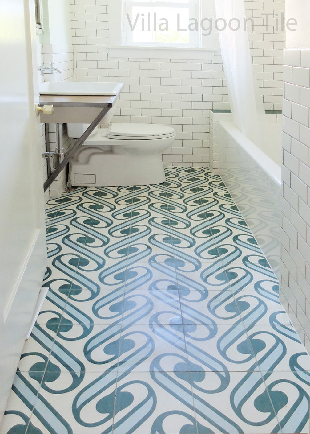 Villa Lagoon Tile's exclusive "Surf Agua" cement tile, paired with subway tiles in a white bathroom.