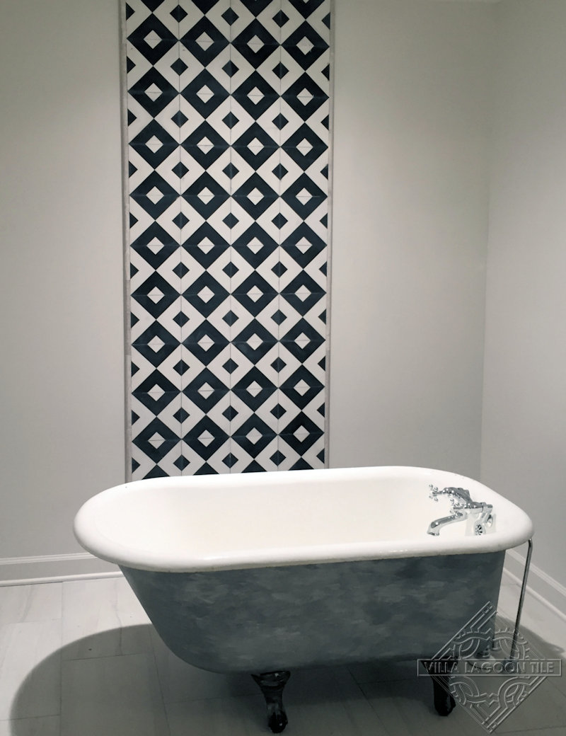 Black and white cement tile feature wall in bathroom.