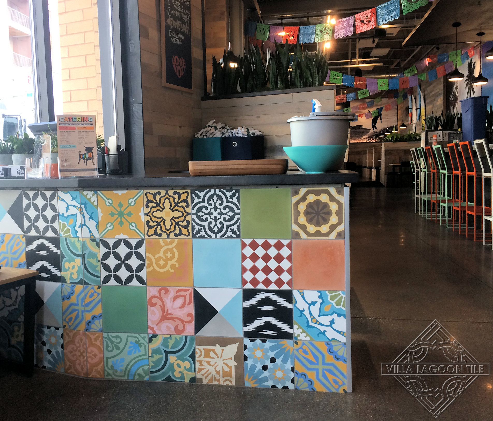 Colorful patchwork cement tile on the front of a Mexican restaurants hostess stand.