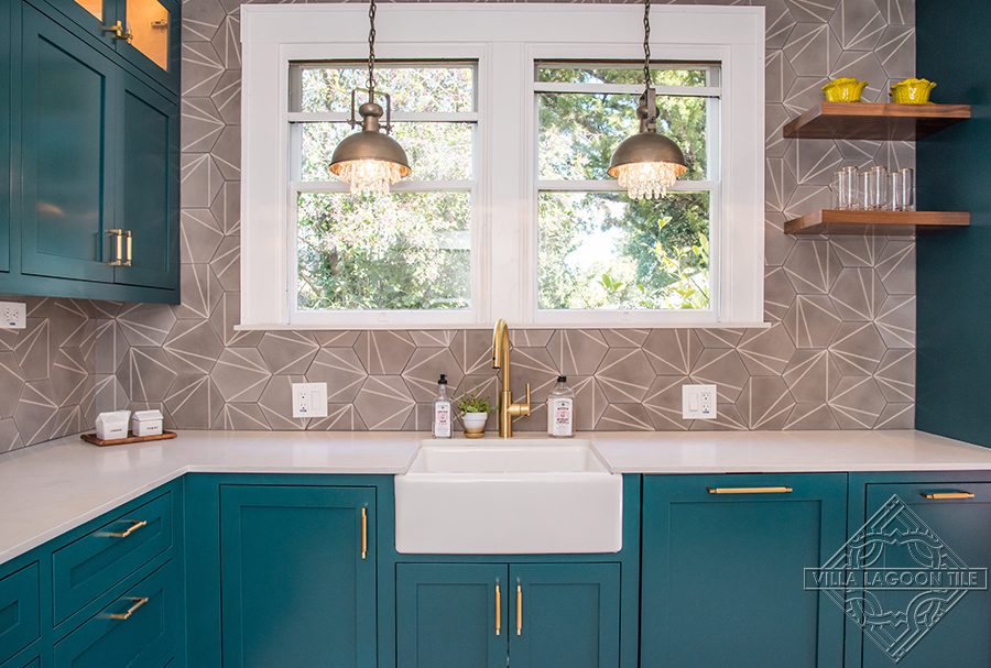 Teal kitchen with our Crow's Feet gray hexagonal shaped tile set on the walls.