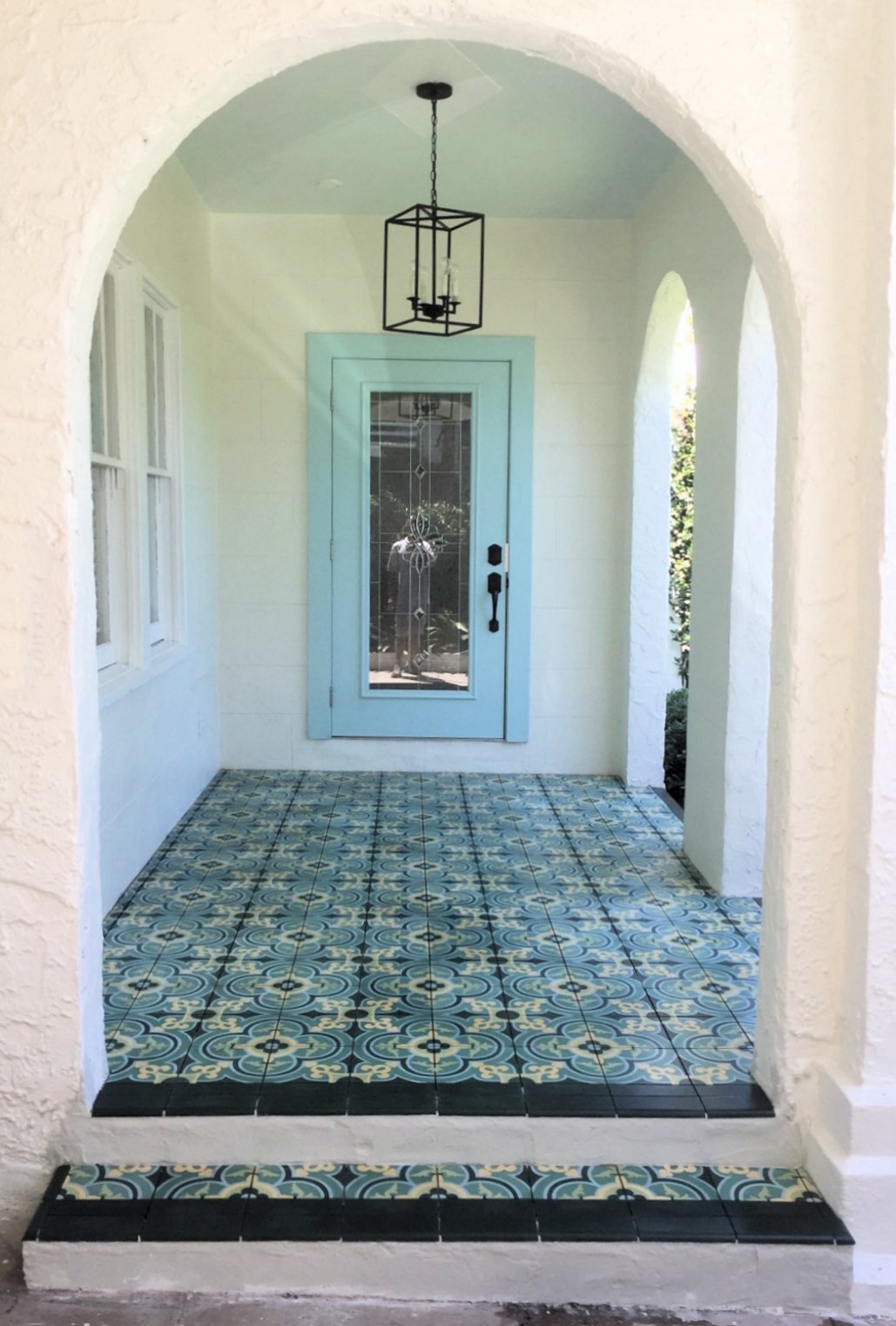 Entryway featuring green french inspired cement tile pattern bordered by solid dark green cement tile.