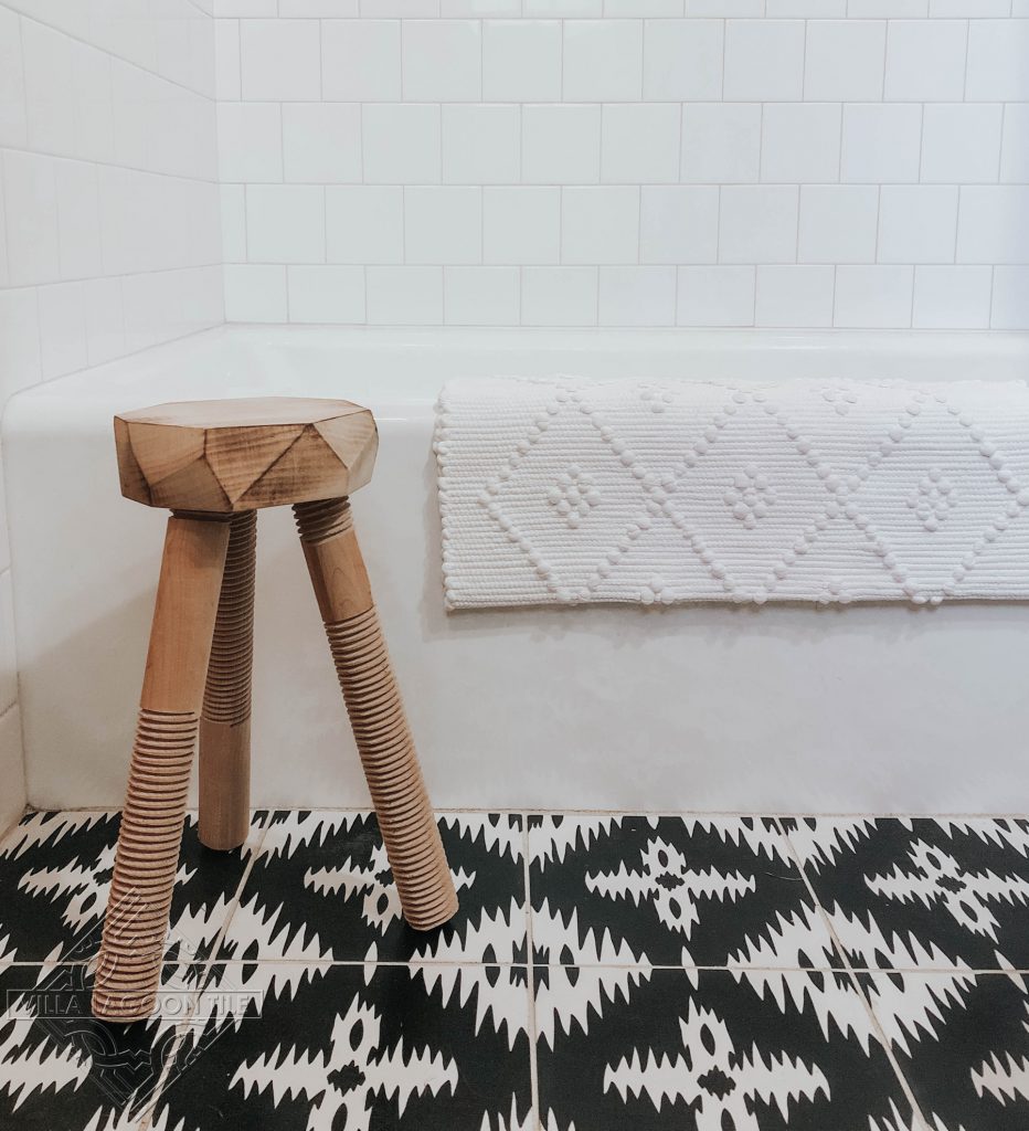 Bathroom floor featuring our Ikat cement tile pattern in black and white.