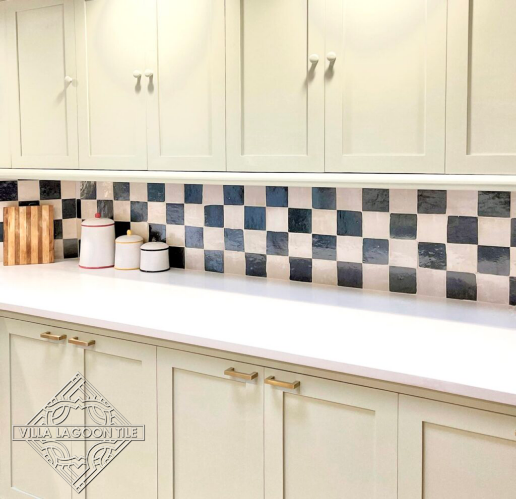 Glossy blue and white checker tiled kitchen backsplash.