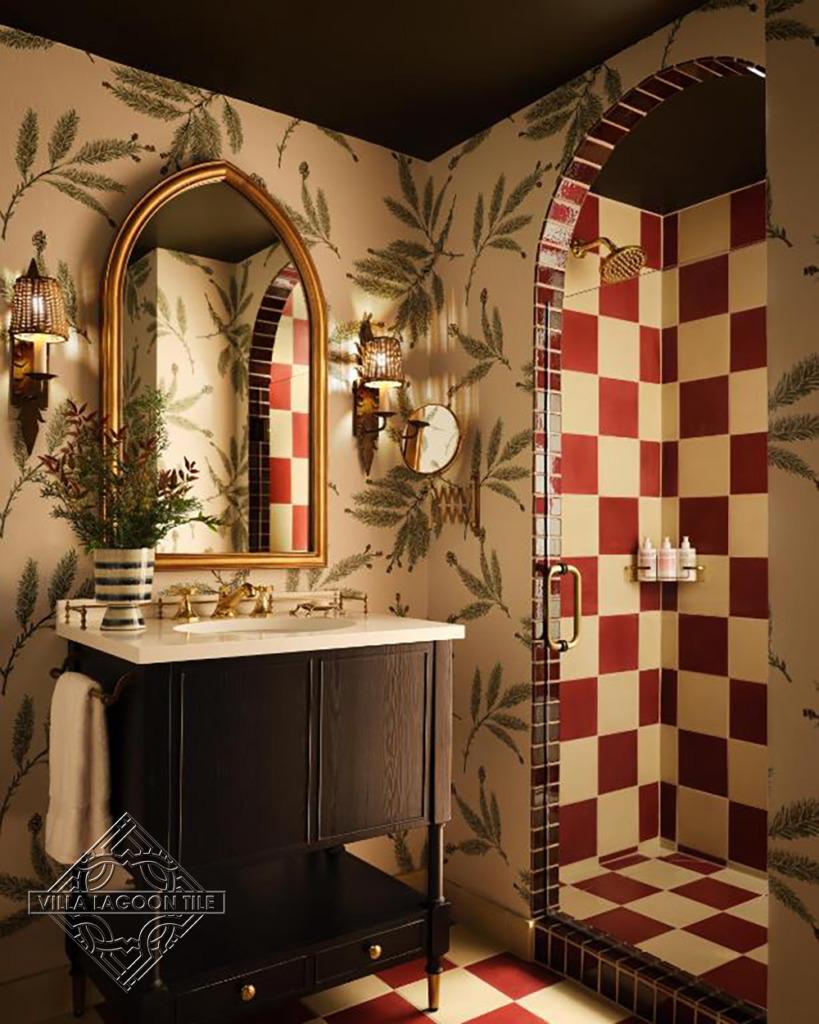 Bathroom with red and cream checker board patterned tiled shower and floor.