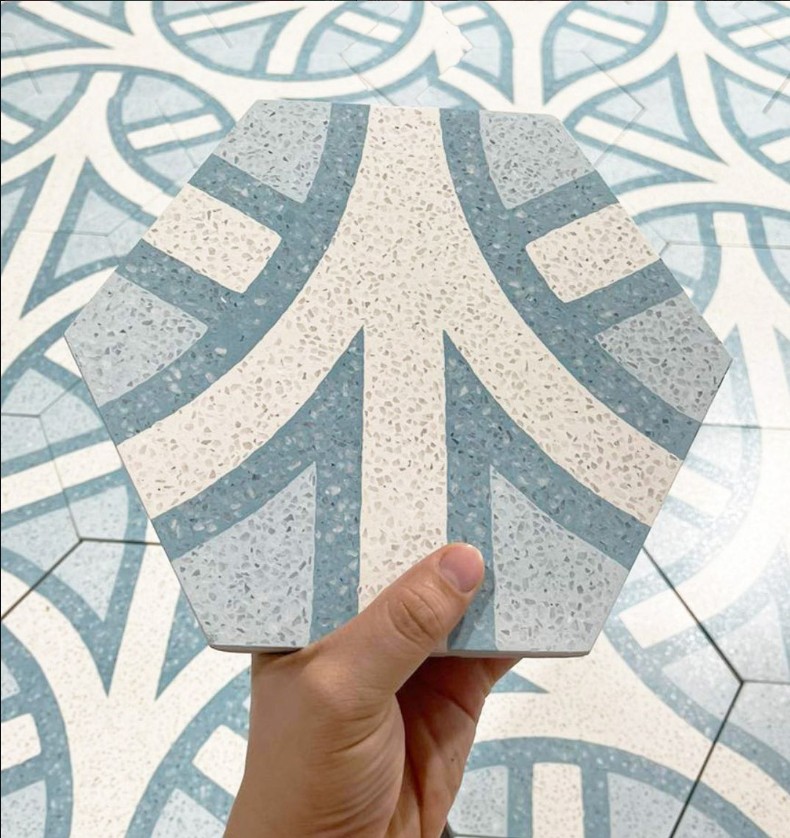 Modern hexagonal tile with terrazzo-style detailing and contemporary blue-gray accents, offering a unique blend of durability, texture, and architectural design appeal.