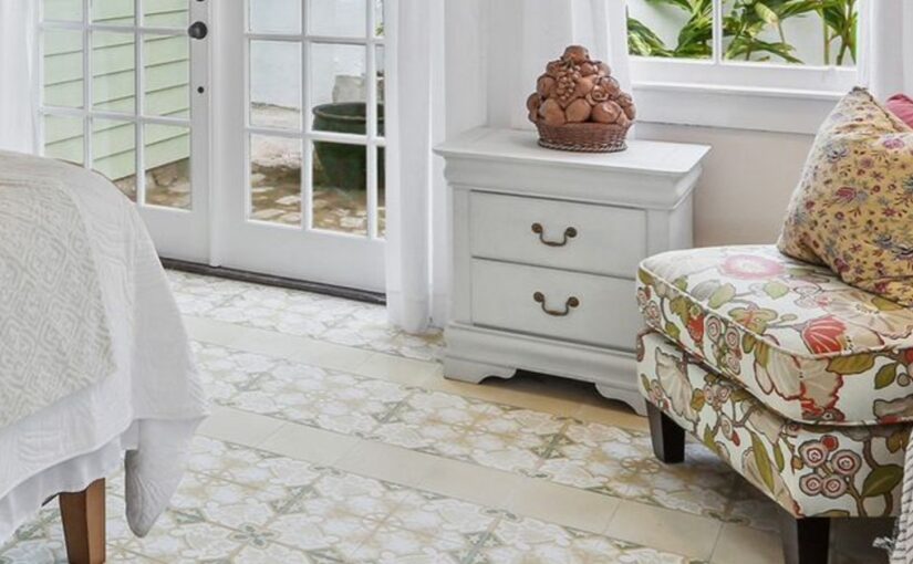 A room with tile flooring and a chair off to the side. There is a door with a window installed into it.