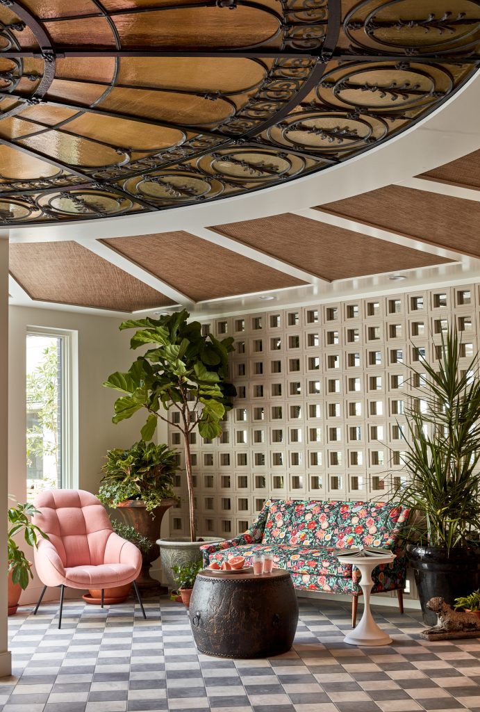 Mid-Century Modern Sunroom Interior with Cement Breeze Blocks, Checkerboard Tile, and Tropical Greenery