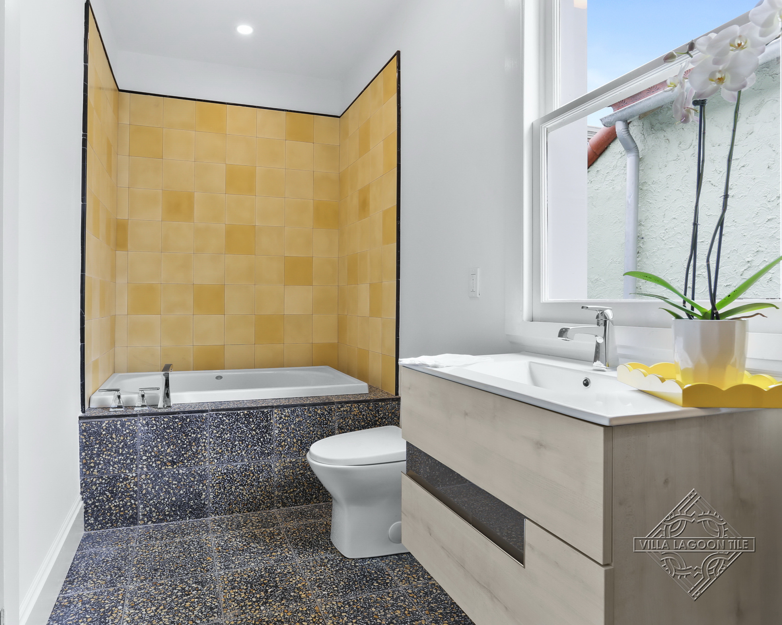 Modern Bathroom Design featuring Terrazzo Bathtub Surround and Yellow Cement Tile