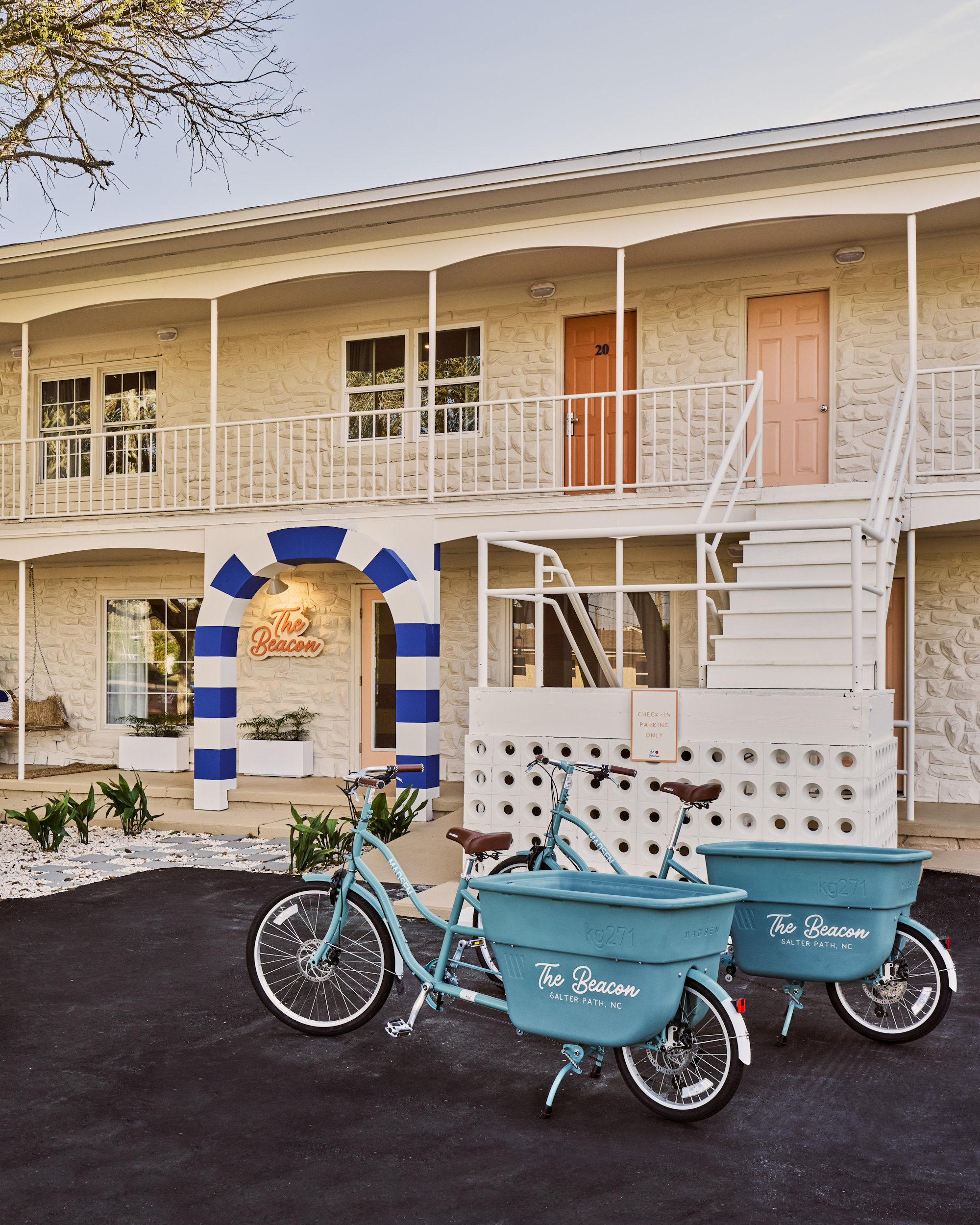 Boutique Coastal Motel Entry with Vintage Cargo Bikes and Mid-Century Modern Architecture
