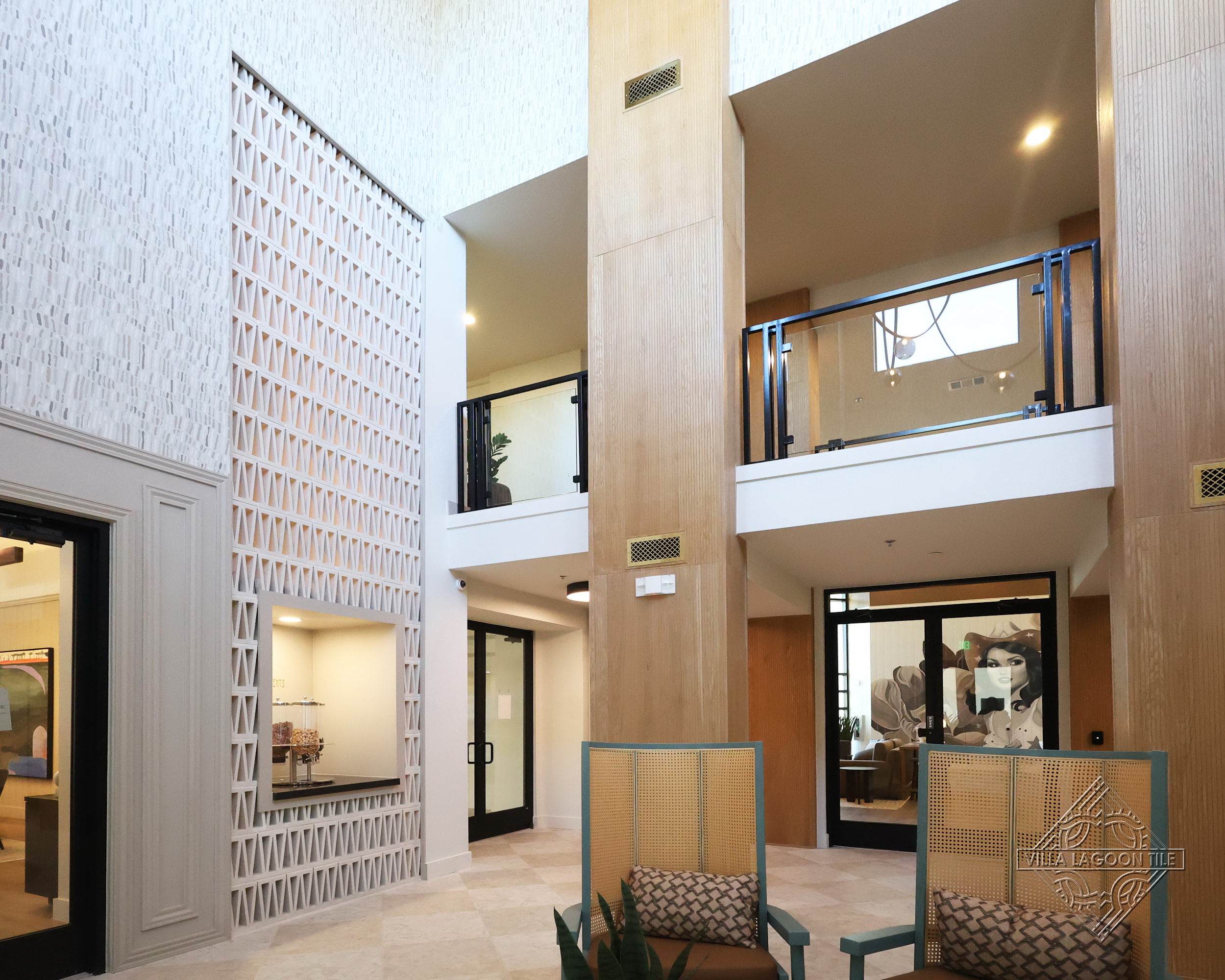 Modern Luxury Apartment Lobby featuring Architectural Breeze Block Screen and Multi-Level Mezzanine