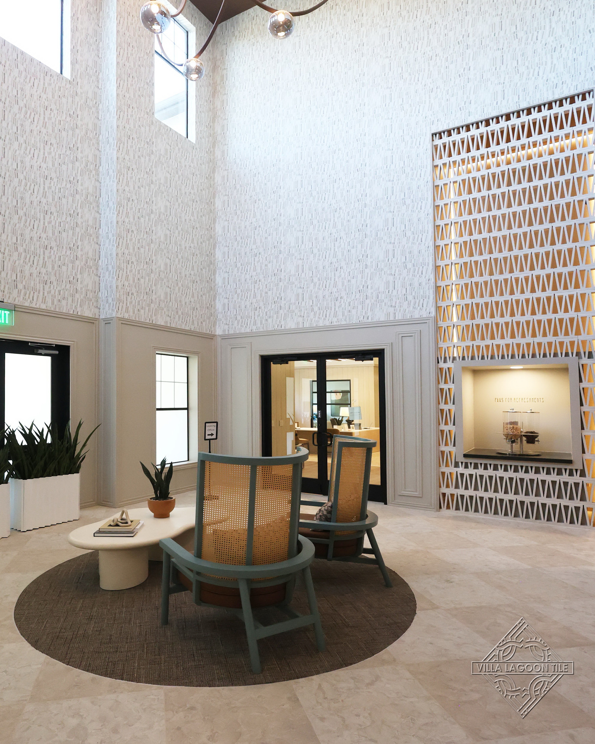 High-Ceiling Luxury Atrium Lobby with Mid-Century Modern Seating and Backlit Breeze Block Wall