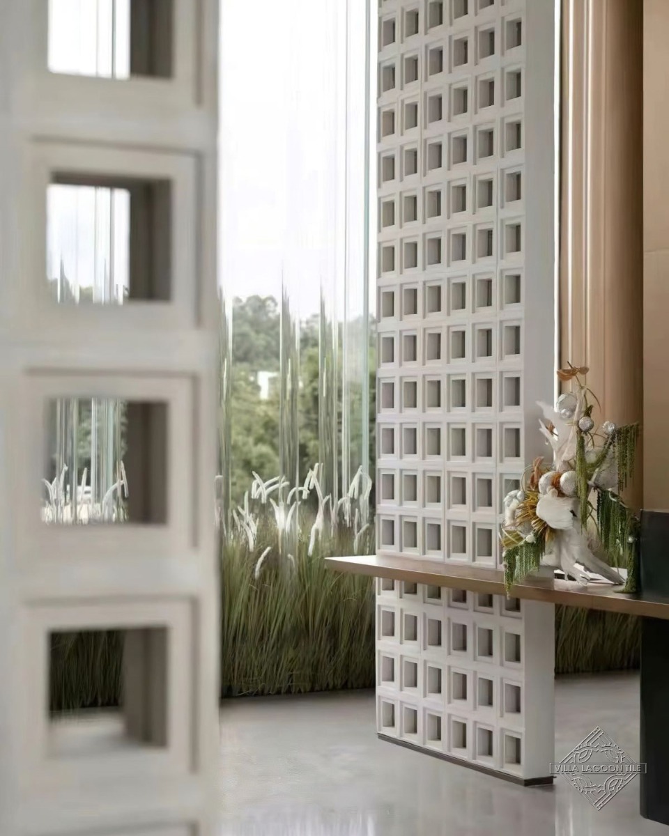 Modern Biophilic Lobby Design with White Breeze Block Screen and Natural Greenery