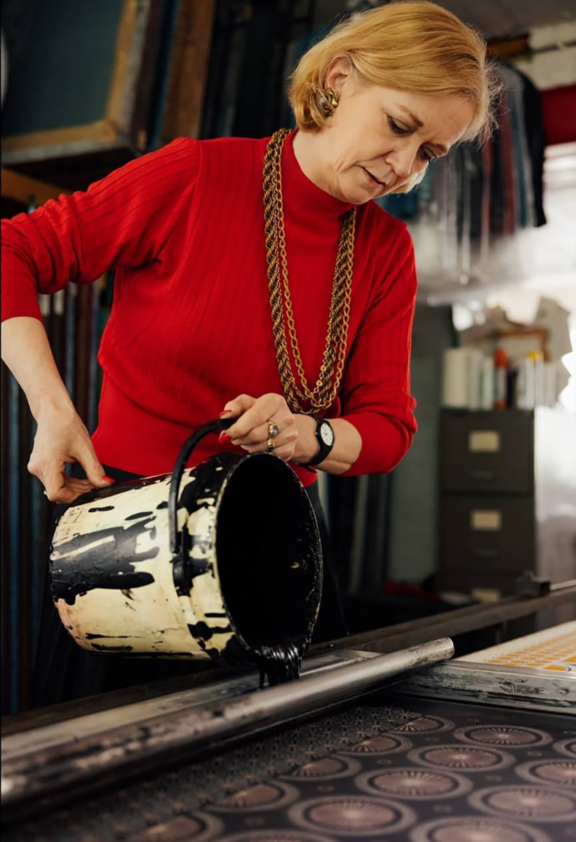 Artist and designer Cressida Bell pouring paint in her London studio.