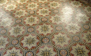 A beautiful antique cement tile floor, in a historic French abbey, photographed on a Villa Lagoon Tile research tour.
