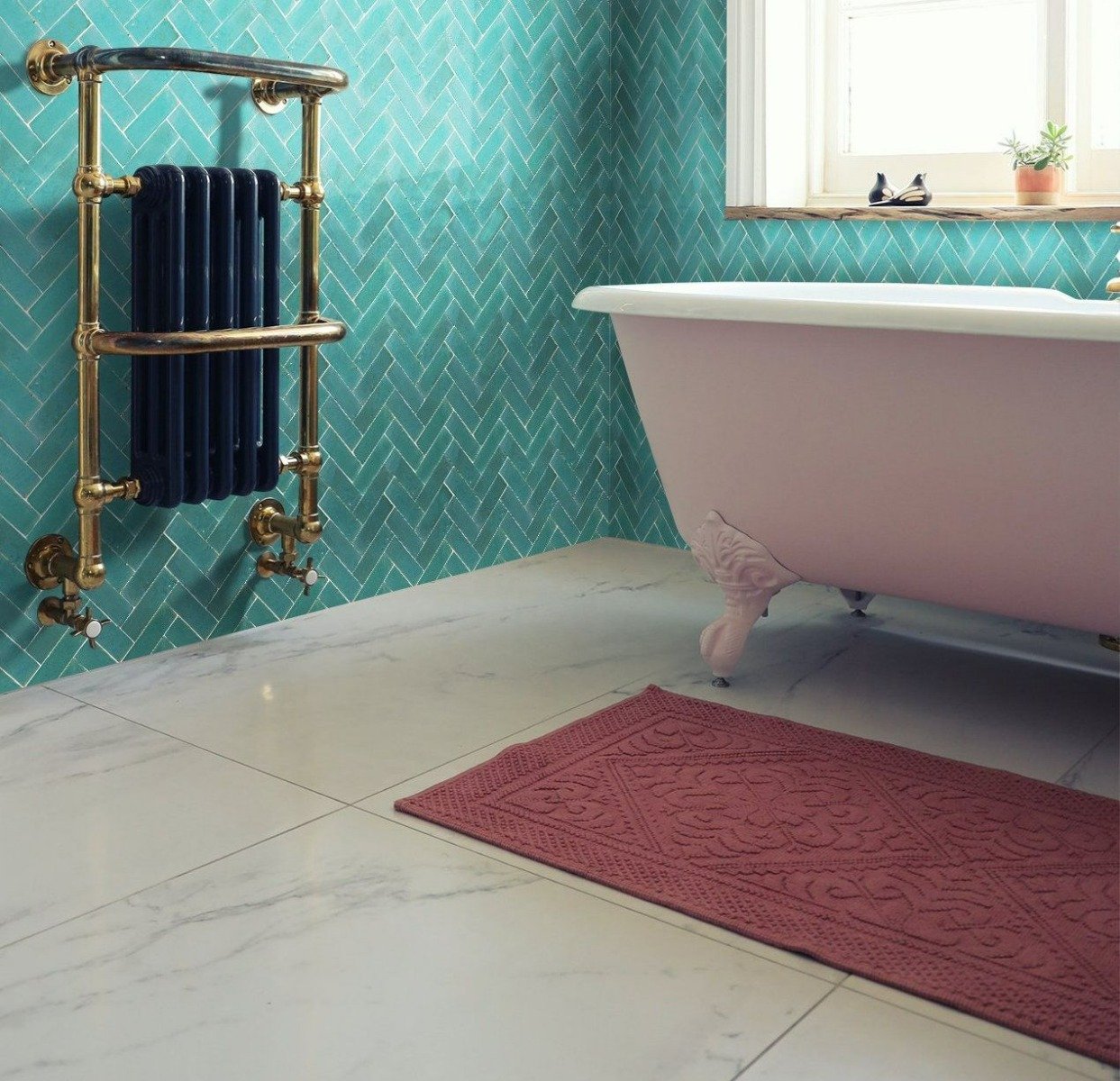 Hand-made Moroccan bejmat, arranged in a herringbone on a bathroom wall.