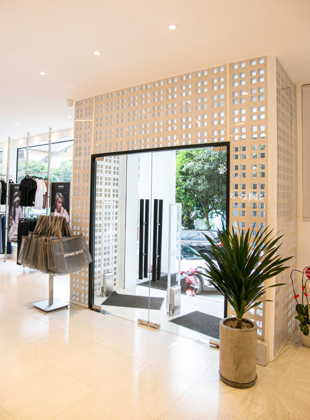 Modern Boutique Interior: Glass Entrance Framed by Architectural Breeze Blocks
